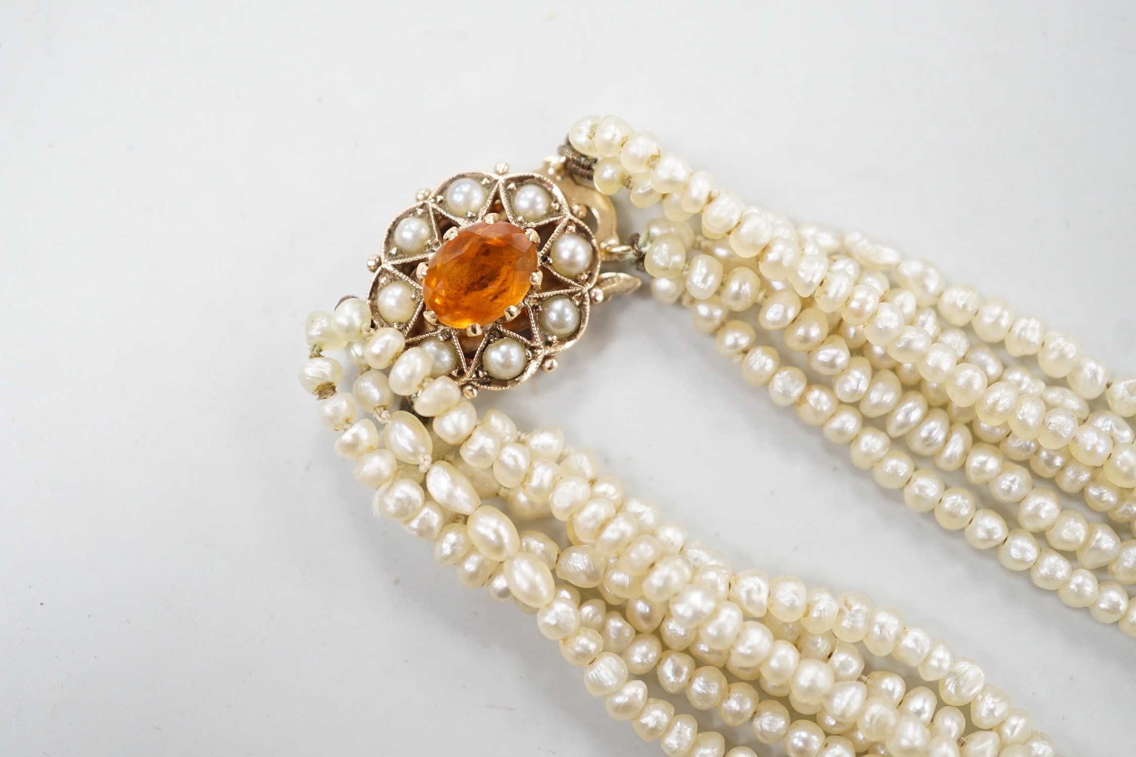 A 1960's Cropp & Farr multi strand seed pearl necklace, with 9ct gold, citrine and split pearl set clasp, 46cm.